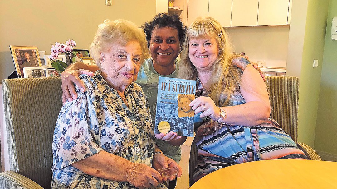 Barbara and Norman Miller handing Lena Goldstein a copy of her book on her 100th birthday 31 January 2019.