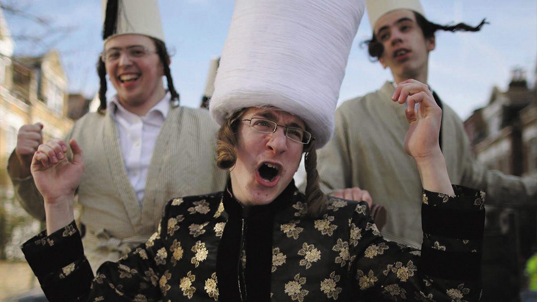 A group of Orthodox Jewish boys dance and sing during the Jewish holiday of Purim. | Photo: Shutterstock