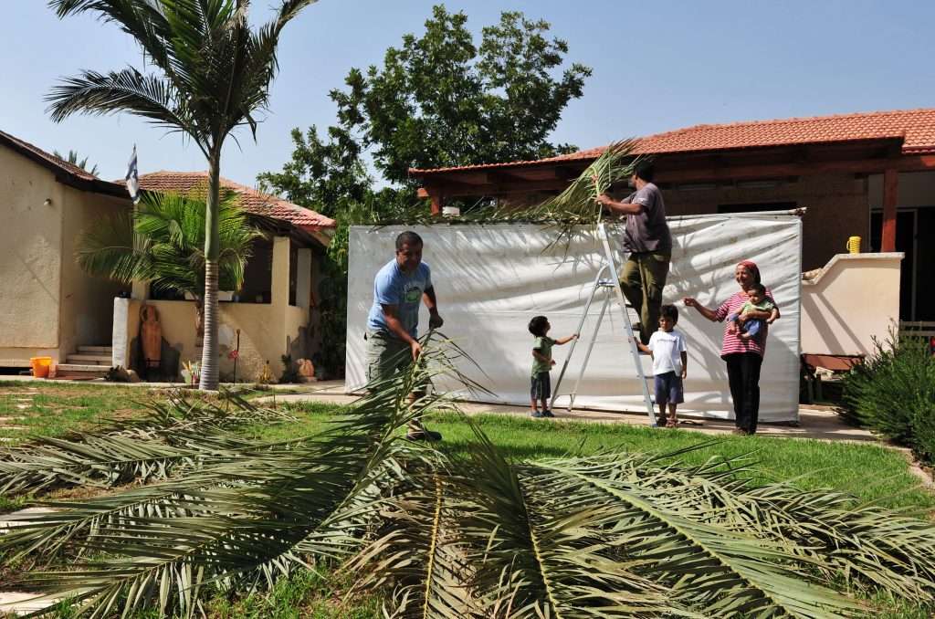 Israeli Jewish family building a Succah